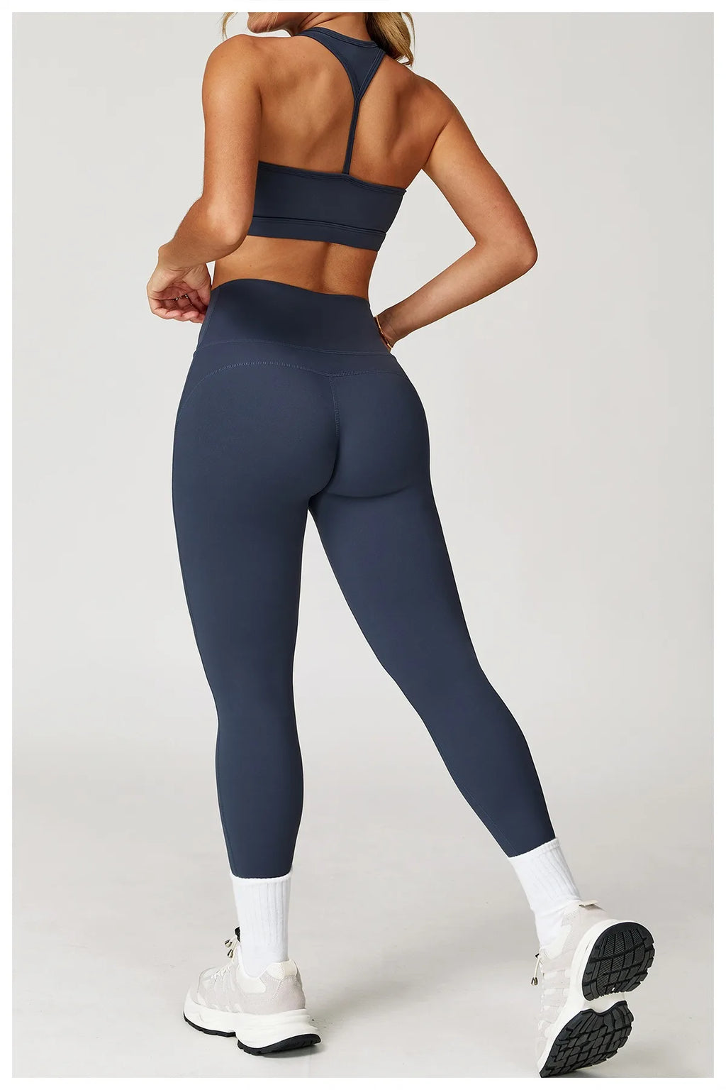 Xooie Fit women's fitness matching set in navy blue with high-waisted leggings and sports bra back view