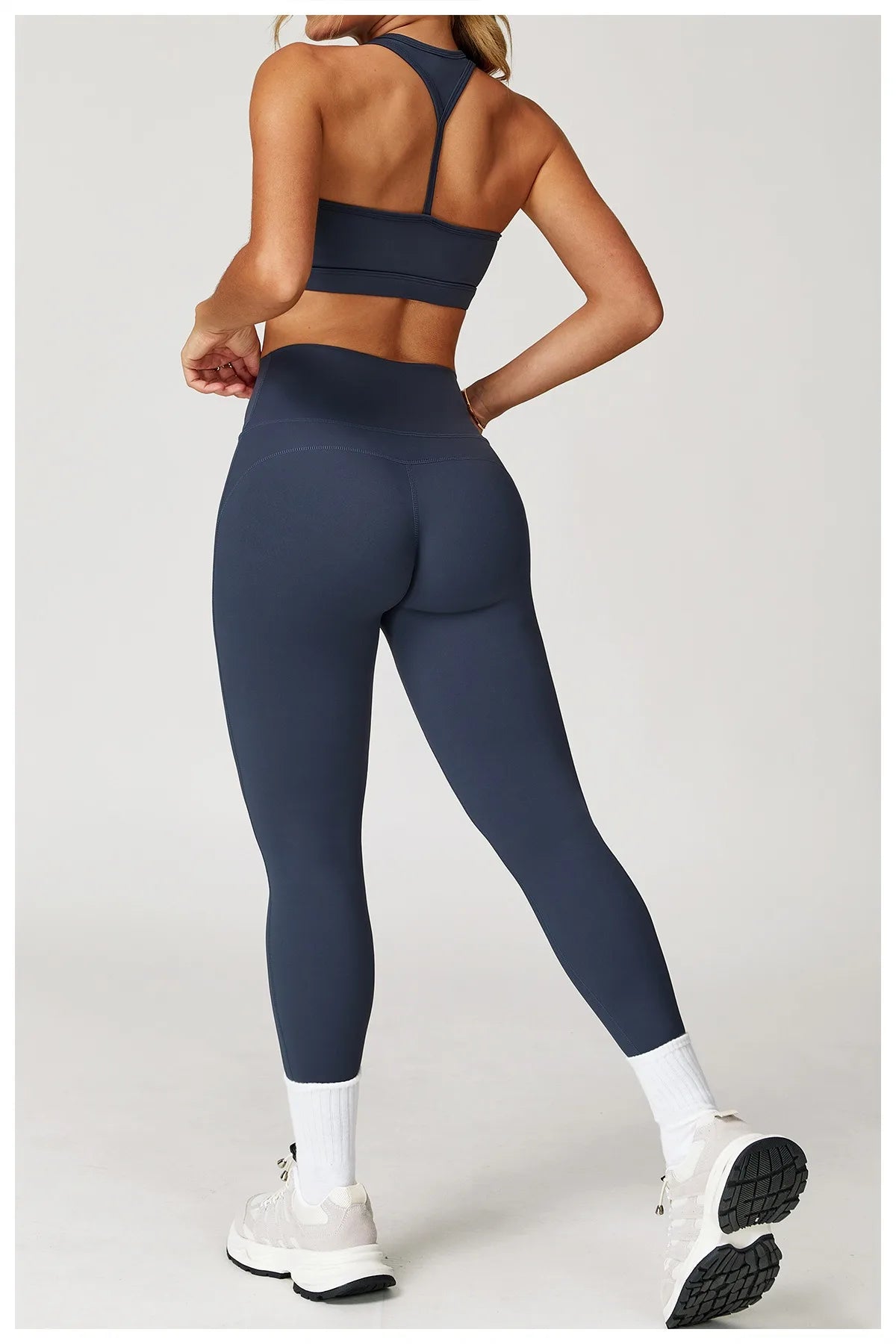 Xooie Fit women's fitness matching set in navy blue with high-waisted leggings and sports bra back view