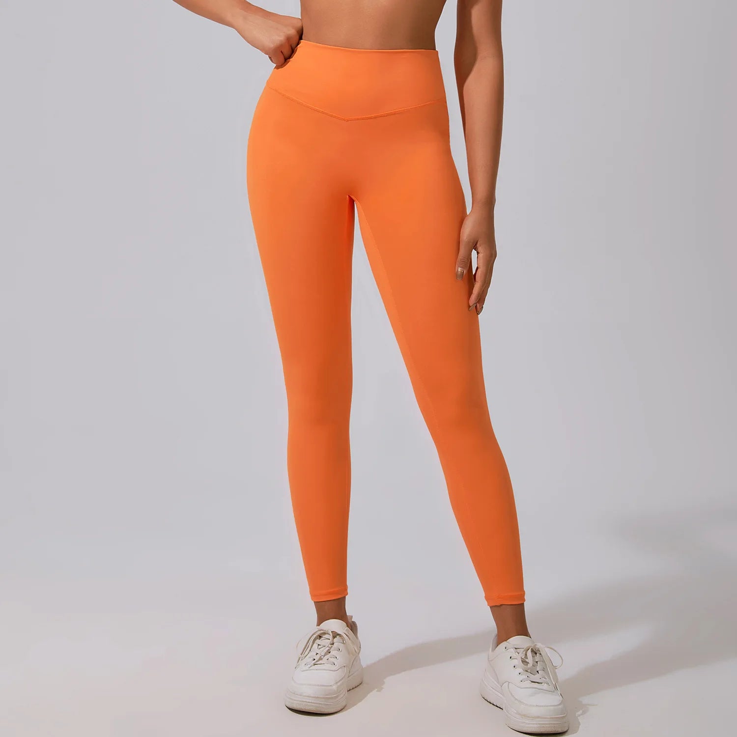 Xooie Fit women's fitness matching set featuring vibrant orange leggings with a high waistband
