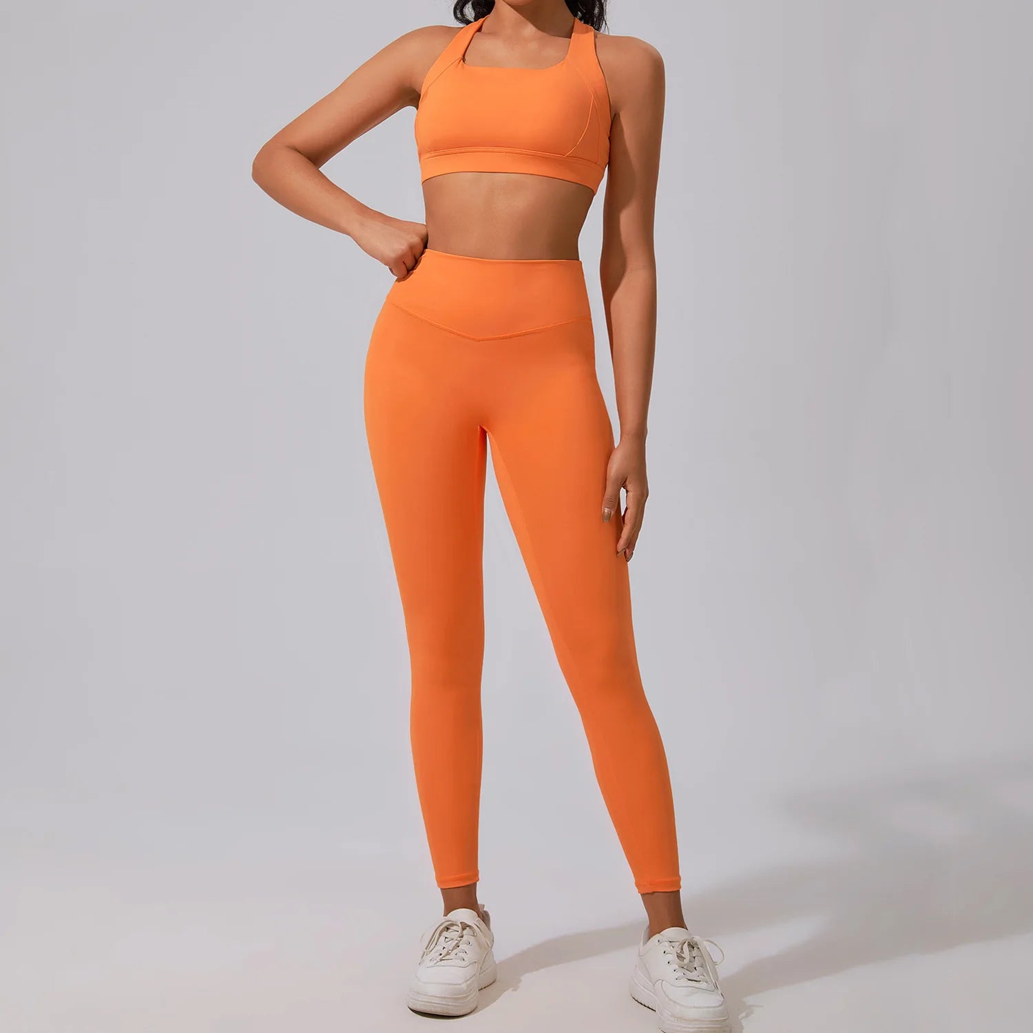 Xooie Fit women's fitness matching set in vibrant orange featuring a crop top and high-waisted leggings
