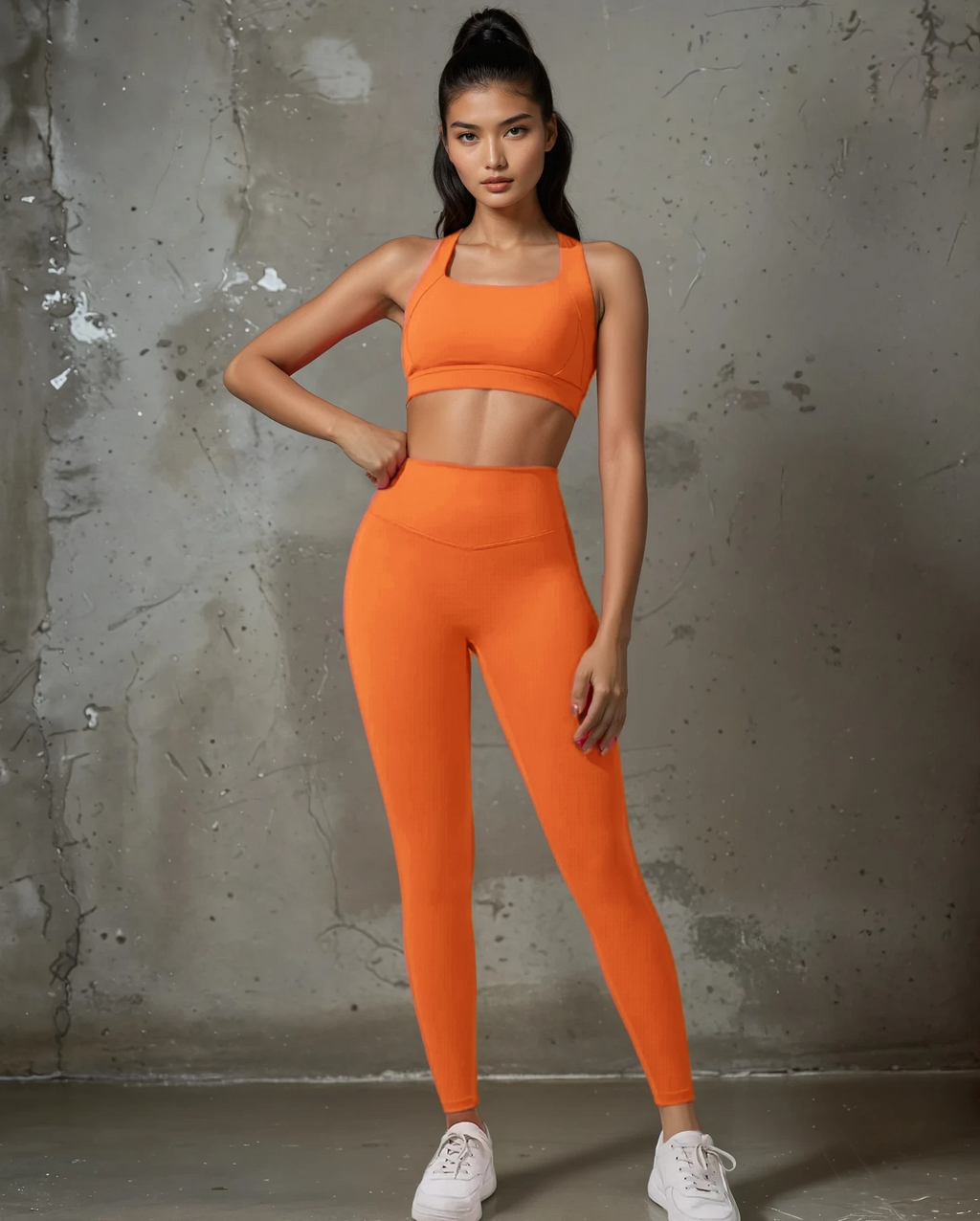 Xooie Fit women's fitness matching set in vibrant orange with a crop top and high-waisted leggings