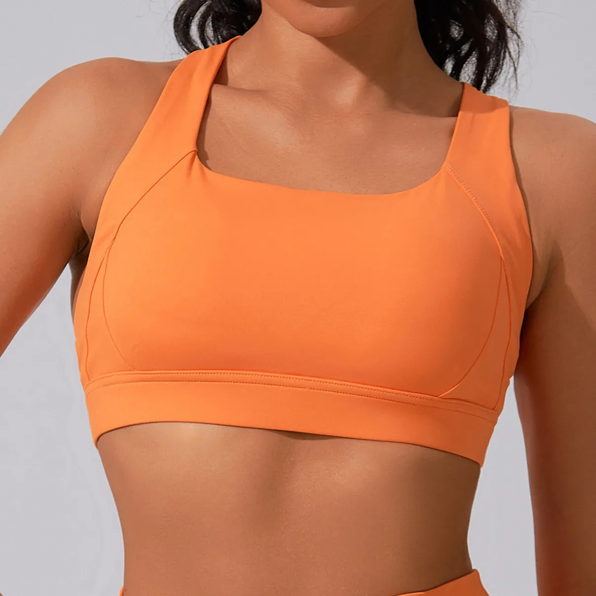 Xooie Fit women's fitness matching set in vibrant orange with a stylish sports bra design