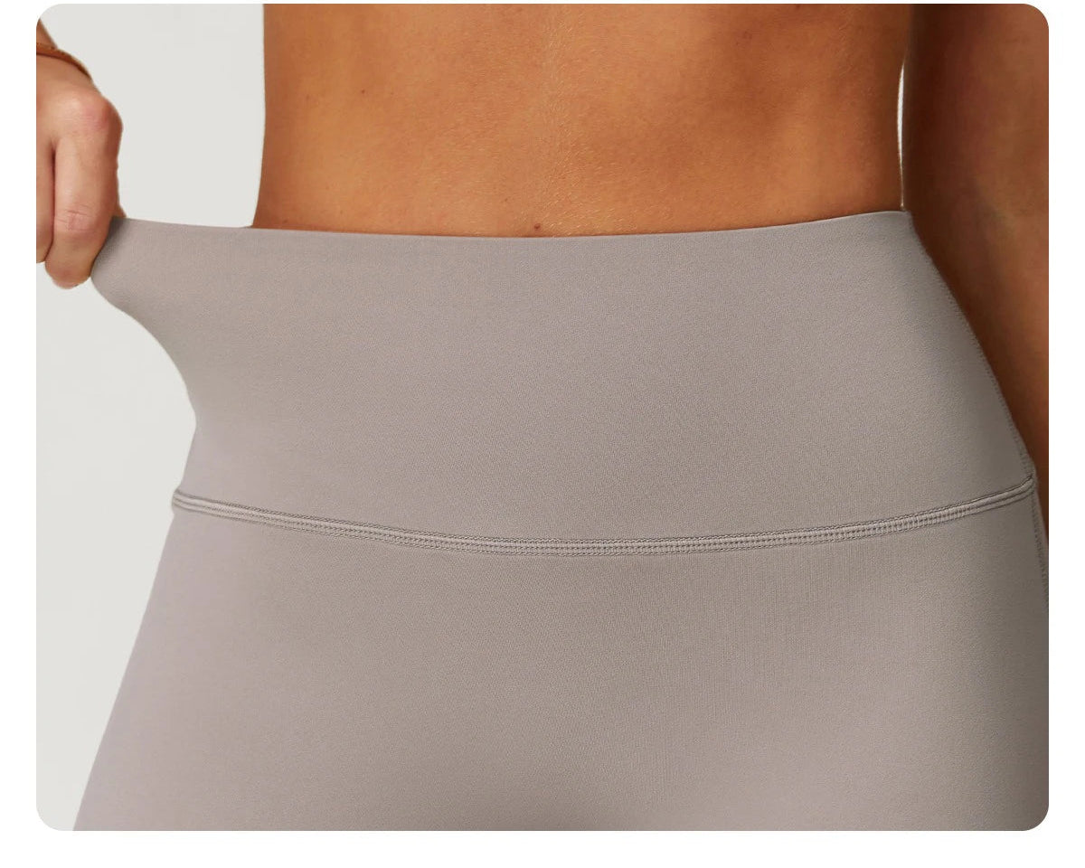 Close-up of stretchy waistband on women's fitness matching set in neutral beige color by Xooie Fit