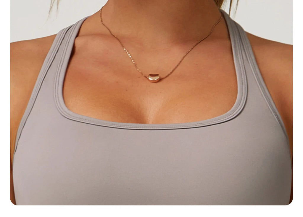 Close-up of women's fitness matching set by Xooie Fit in light gray with square neckline
