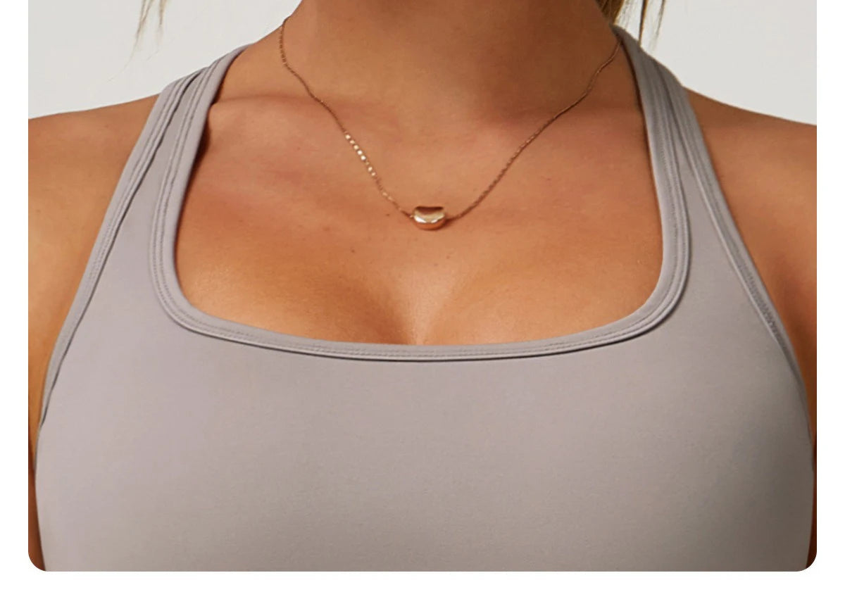 Close-up of women's fitness matching set by Xooie Fit in light gray with square neckline