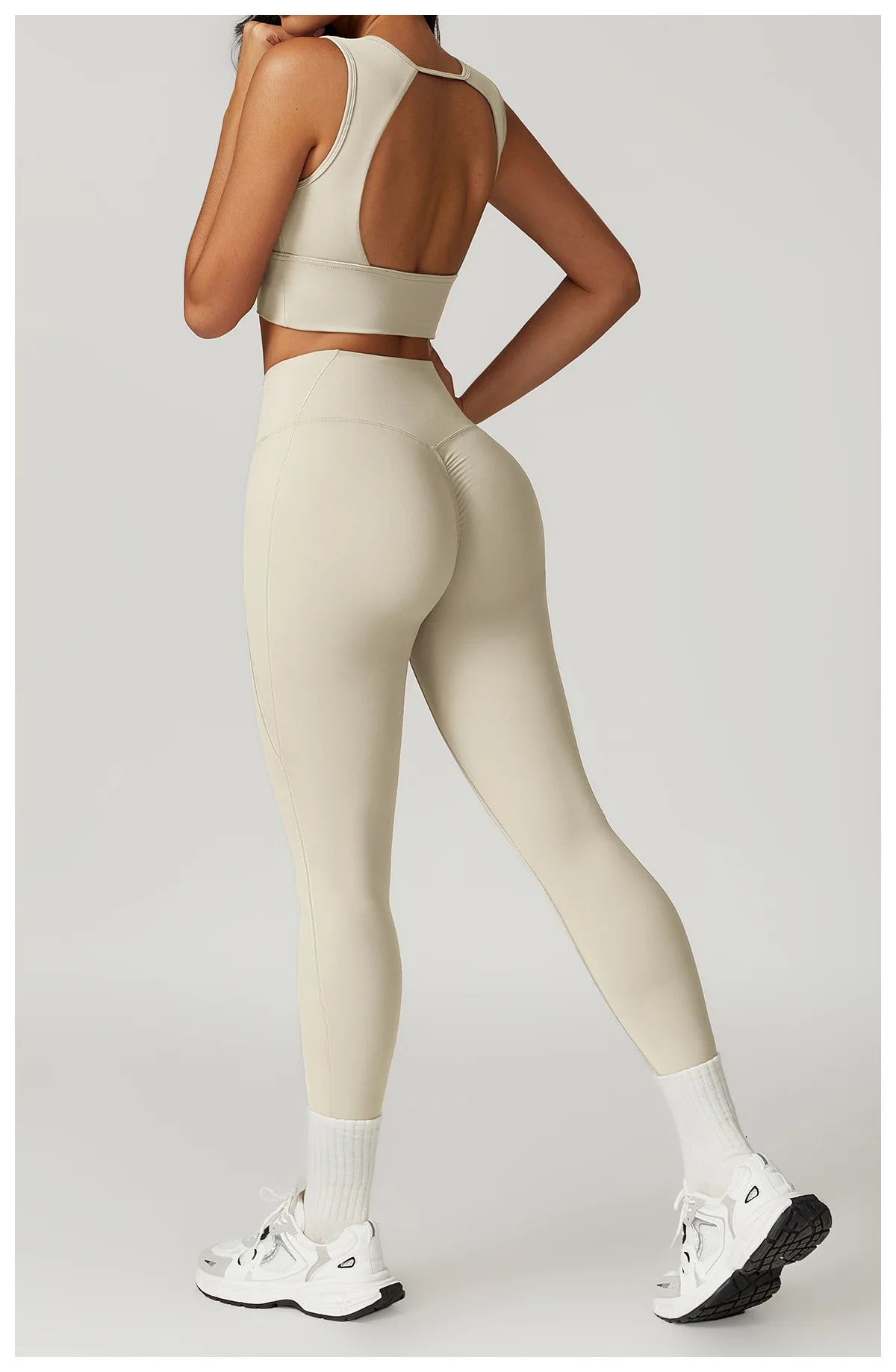 Stylish women's fitness two-piece set in beige with a cropped top and high-waisted leggings
