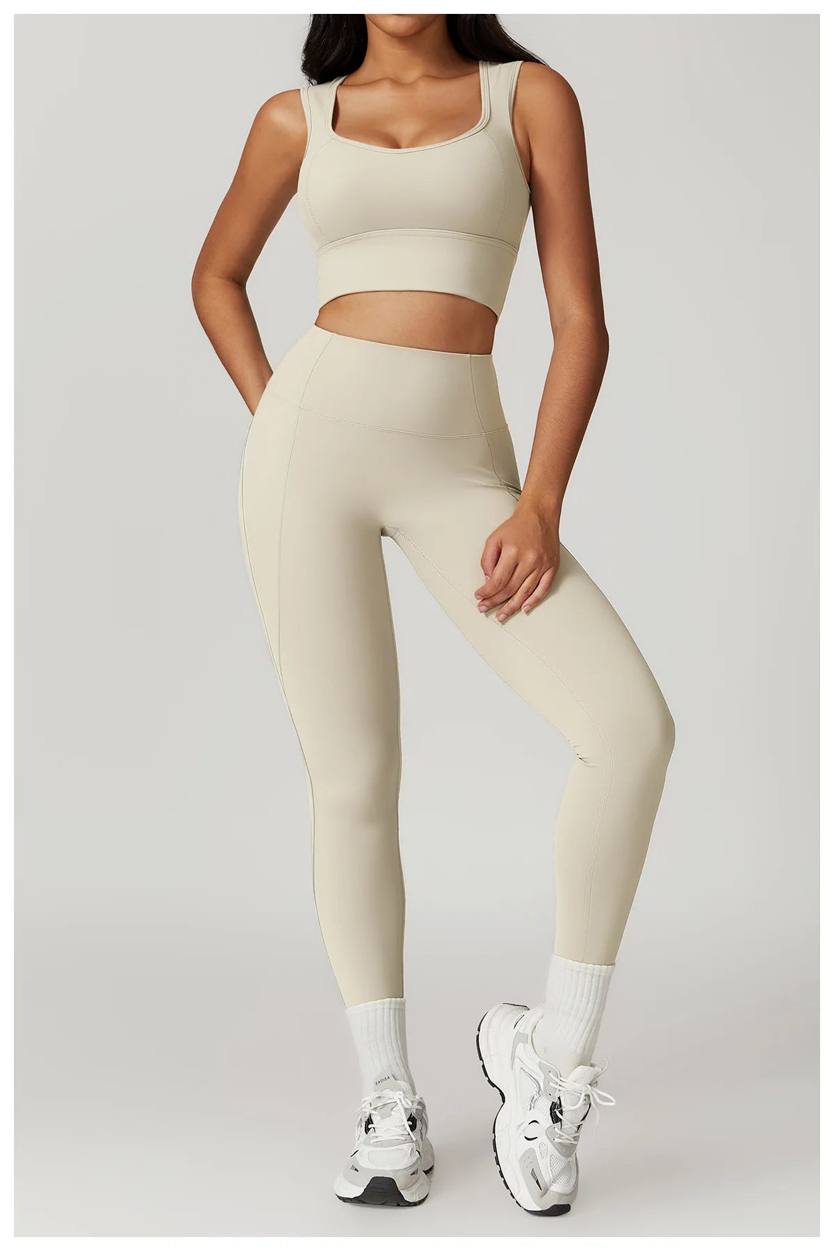 Xooie Fit women's fitness two-piece set in beige featuring a sporty crop top and leggings