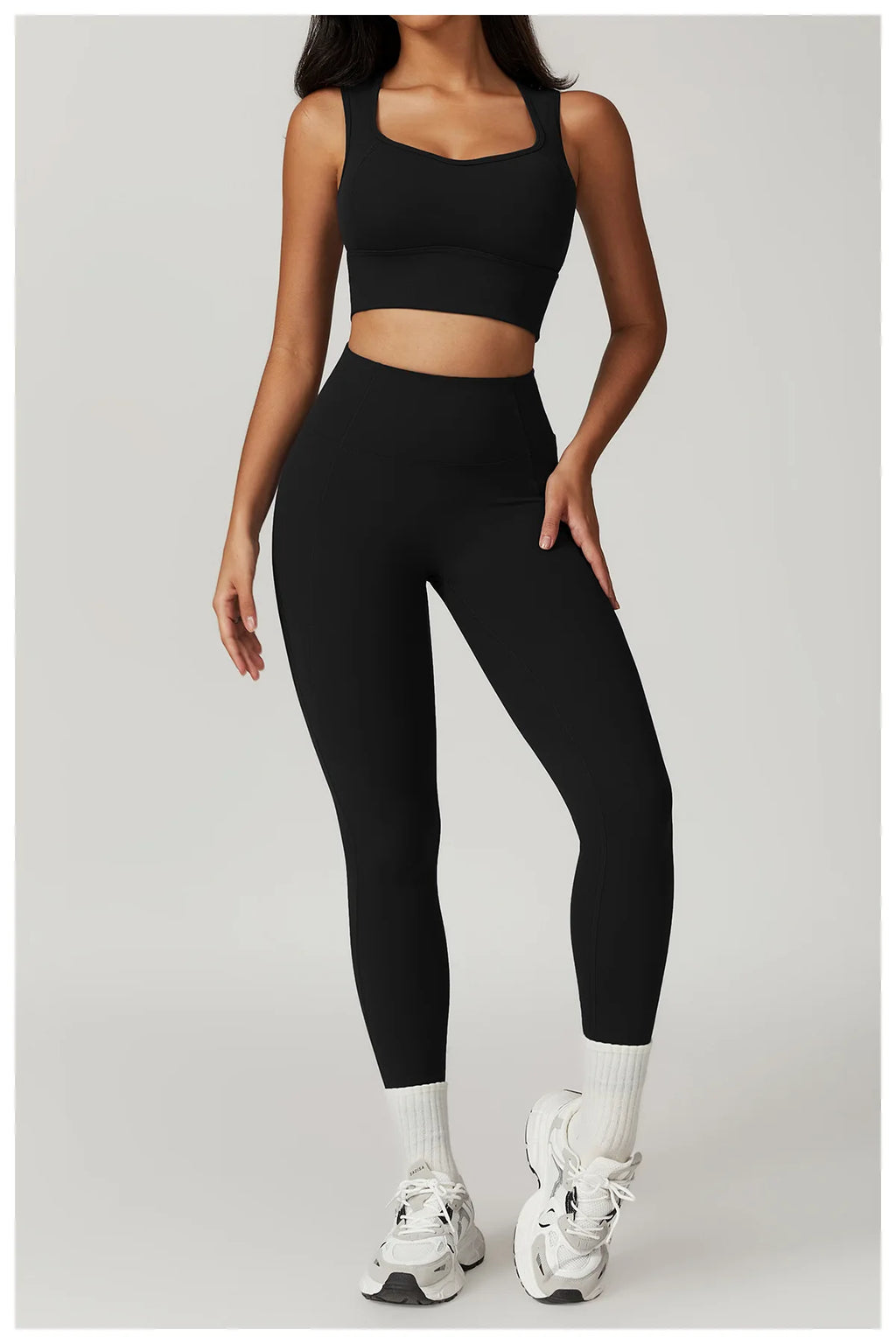 Xooie Fit women's fitness two-piece set in black, featuring a cropped top and high-waisted leggings