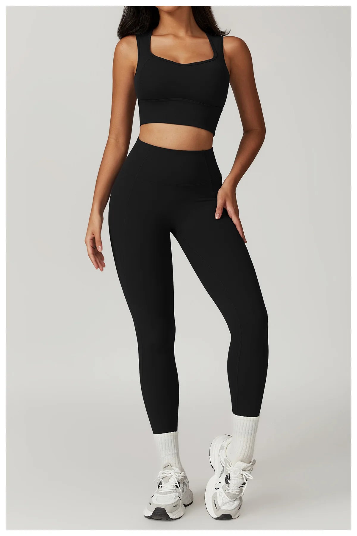 Xooie Fit women's fitness two-piece set in black, featuring a cropped top and high-waisted leggings