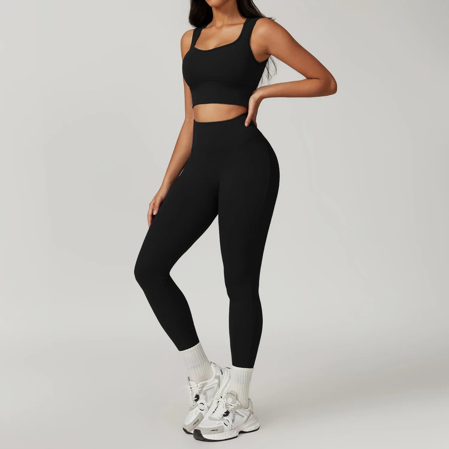Xooie Fit women's fitness two-piece set in black featuring a crop top and high-waisted leggings