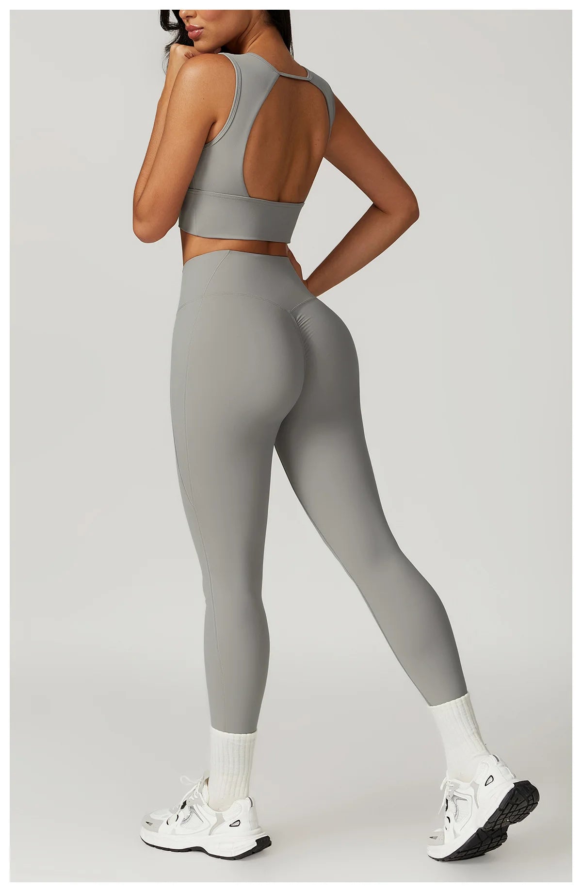 Stylish Xooie Fit women's fitness two-piece set in gray, featuring a crop top and legging combination