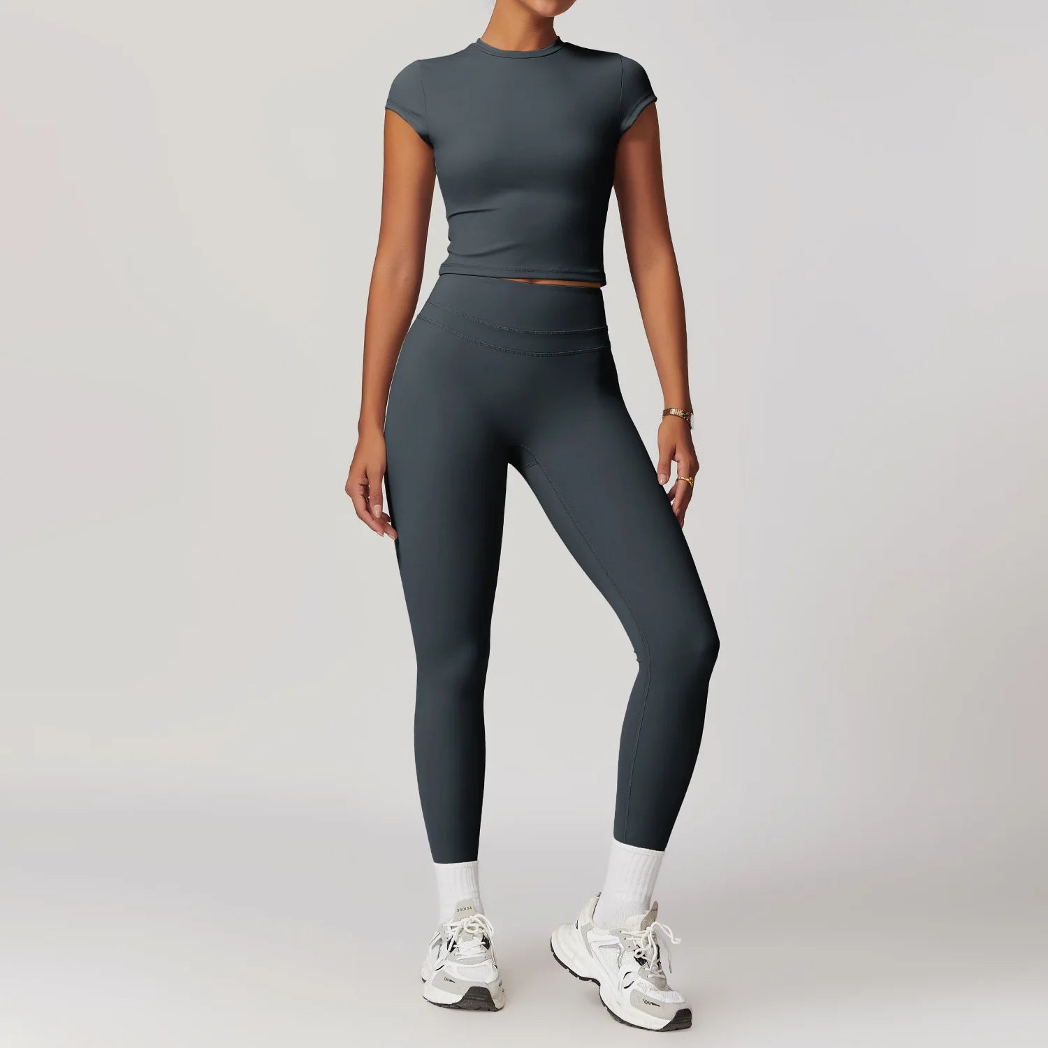 Women's fitted activewear set by Xooie Fit in dark gray with cropped short sleeve top and high-waisted leggings