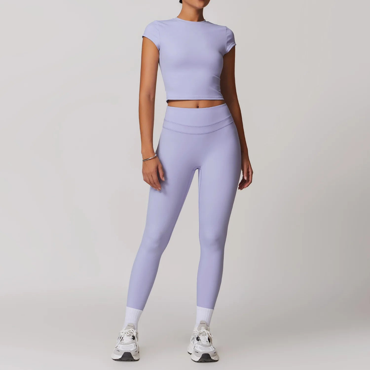 Xooie Fit women's fitted activewear set in lavender with short sleeve crop top and high-waisted leggings