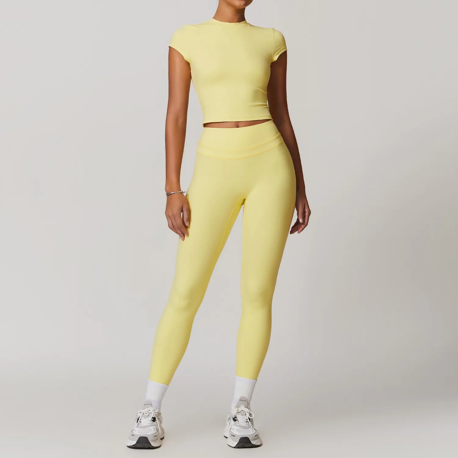 Xooie Fit women's fitted activewear set in yellow with high-waisted leggings and short sleeve crop top