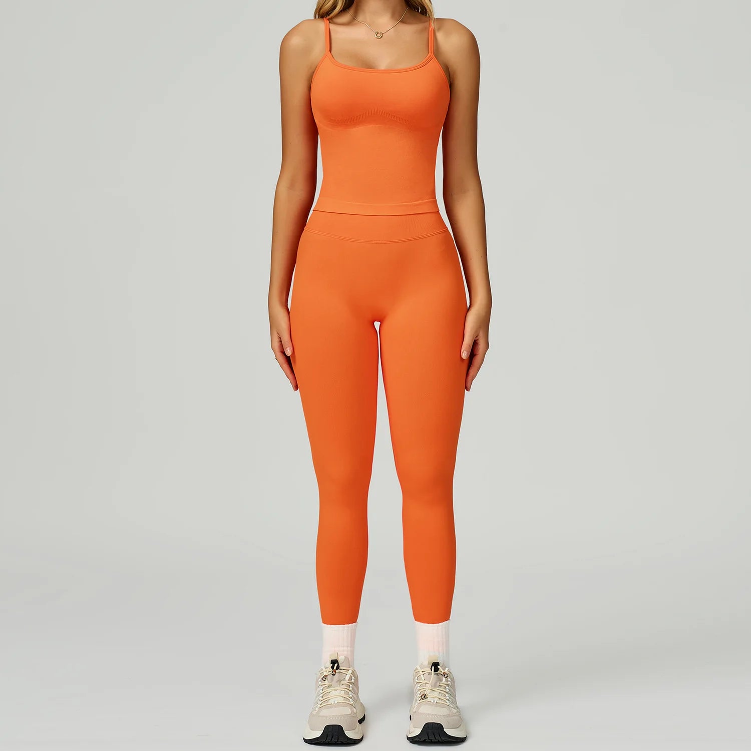 Xooie Fit women's fitted tank top and leggings set in vibrant orange for stylish workouts