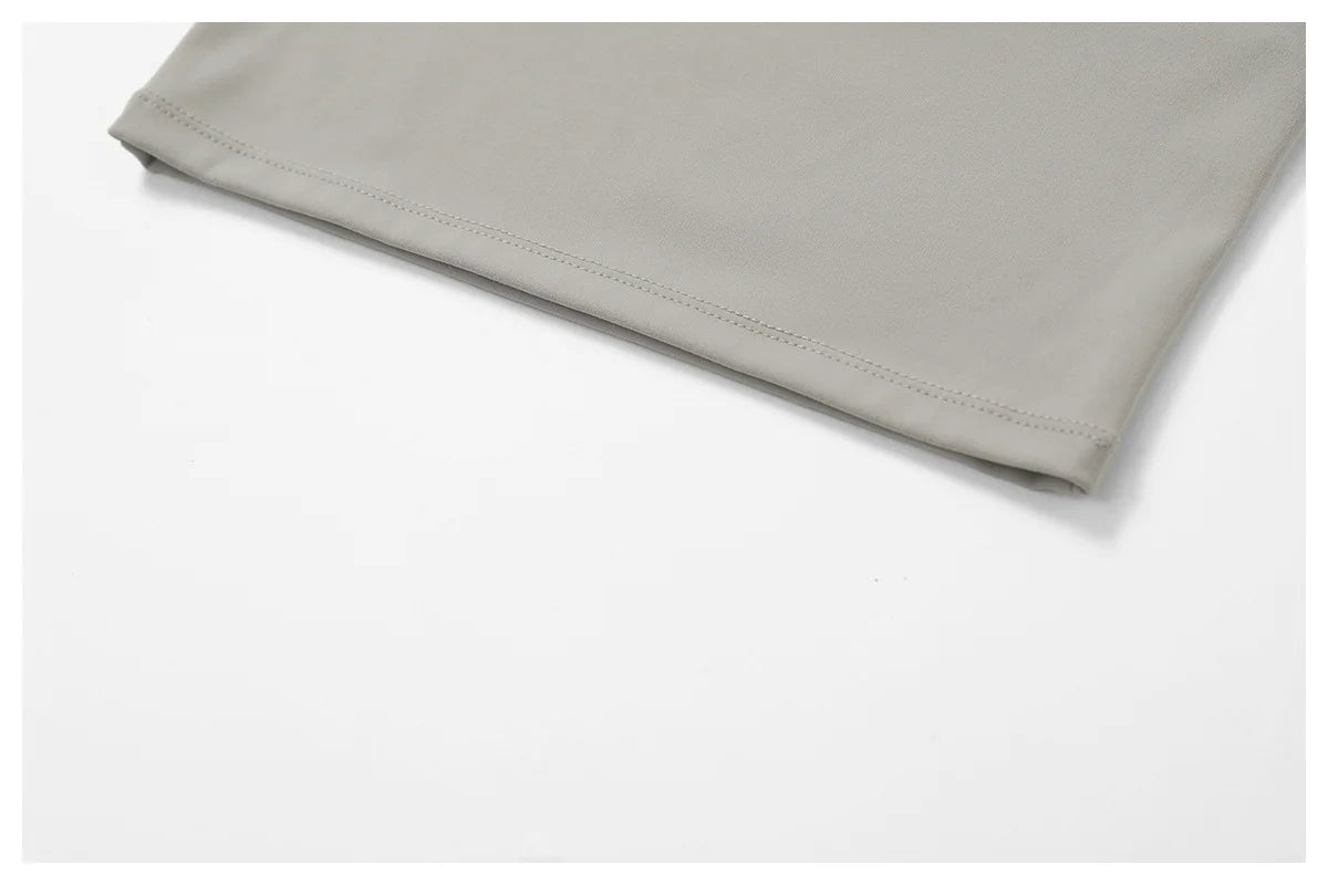Light gray fabric detail of Xooie Fit women's flared fitness set showcasing soft material and stitching