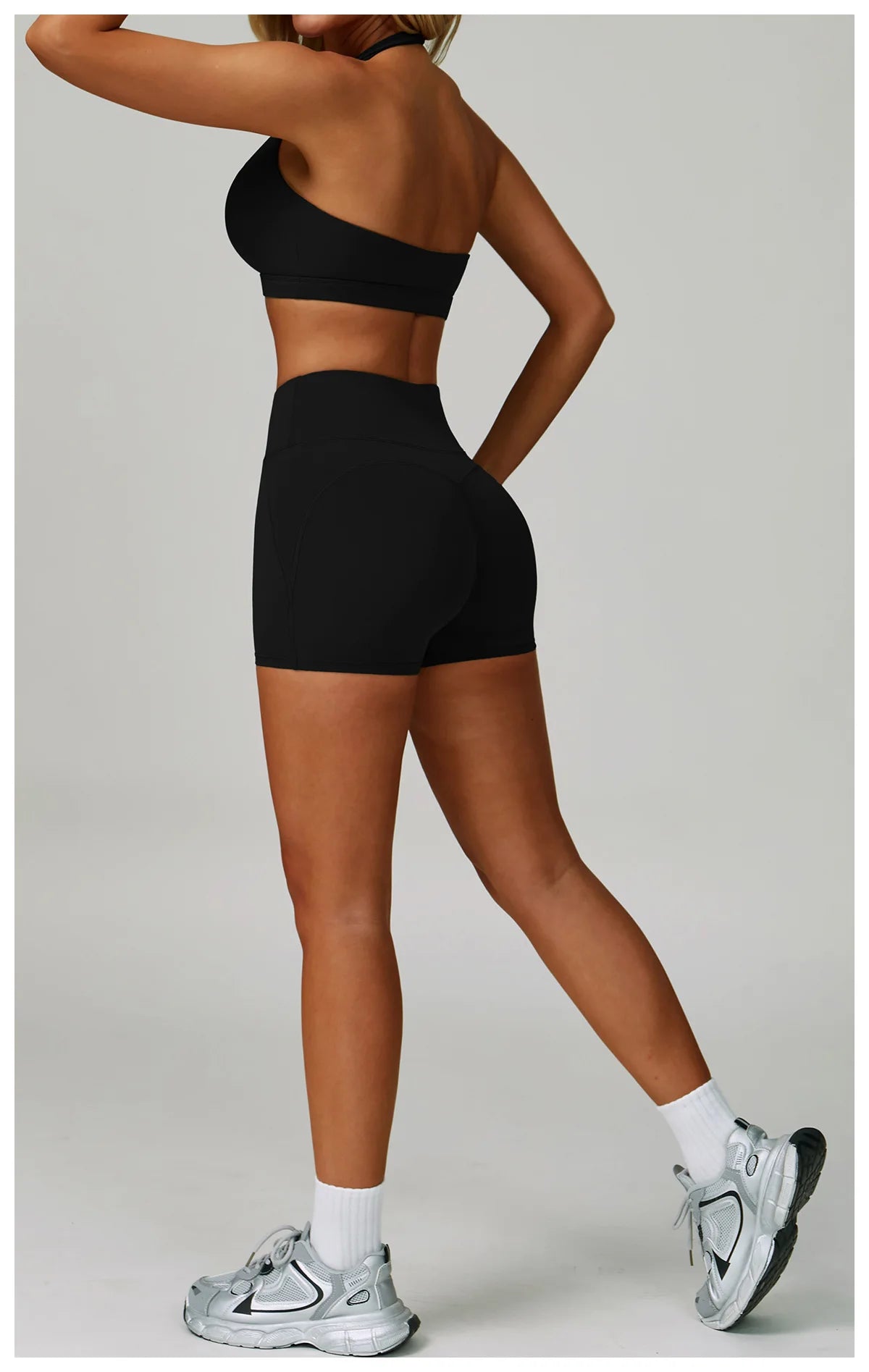 Black scoop-neck sports bra with matching biker shorts set, high-rise waist