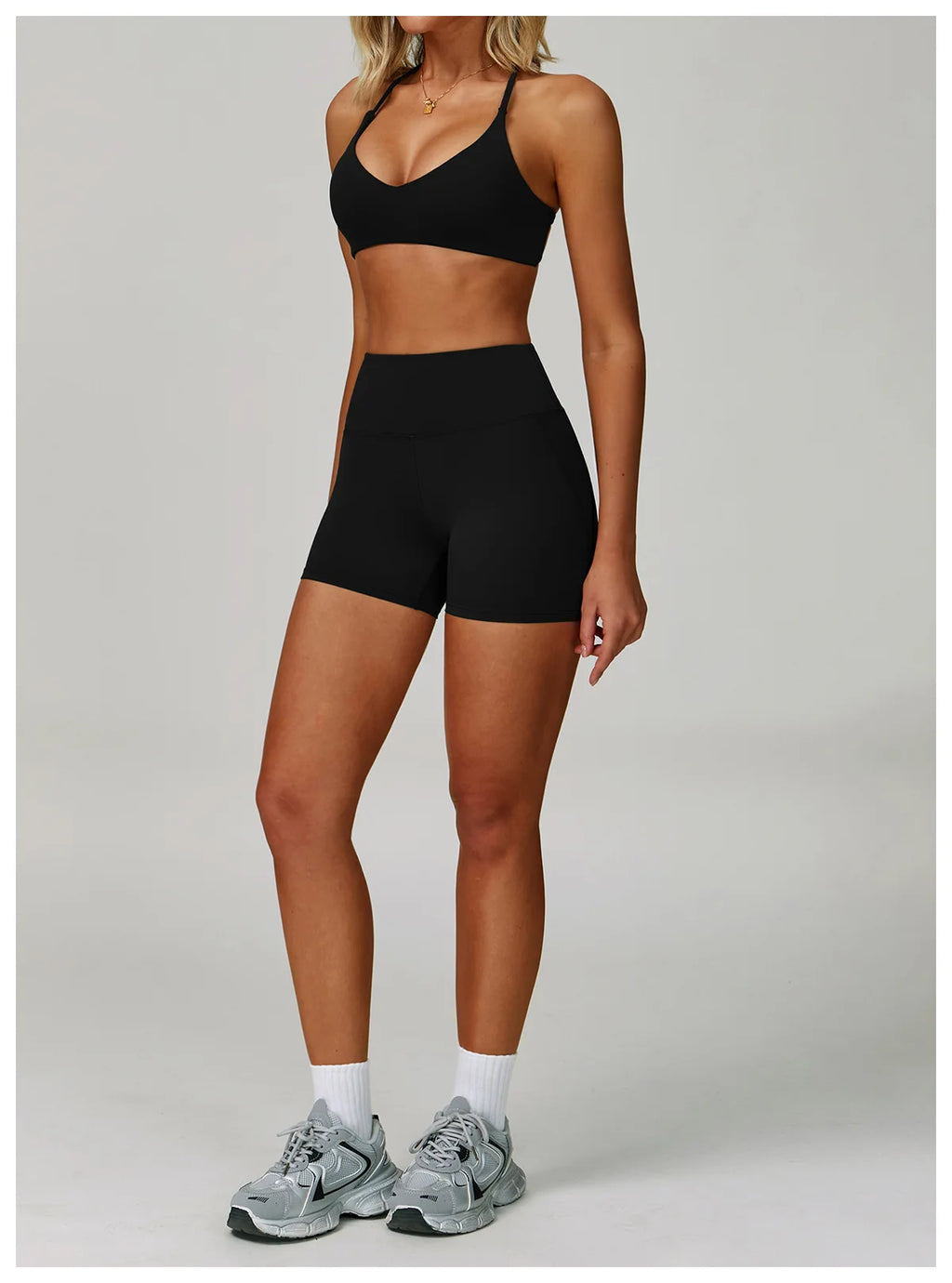 Black halter sports bra and matching active shorts set, front view