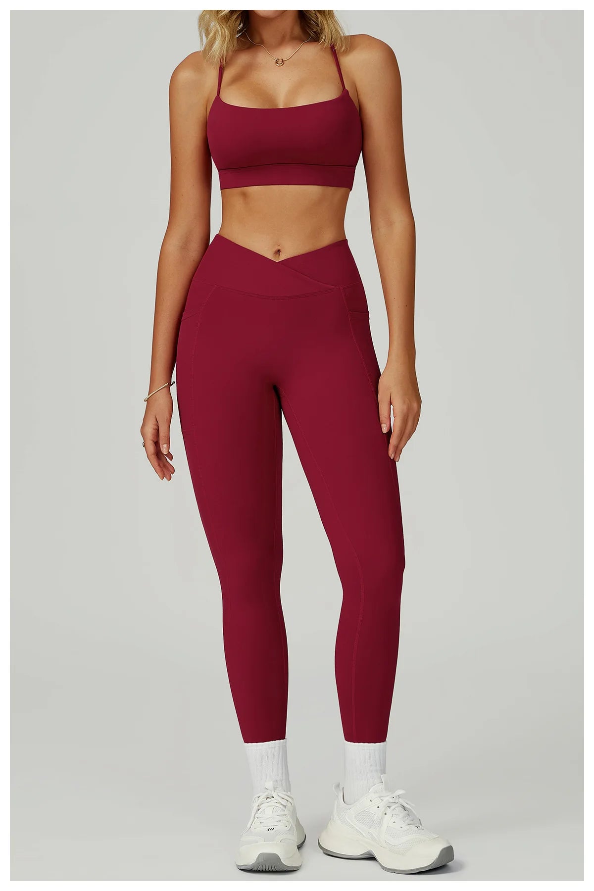 Wine red sports bra and matching leggings set with pockets and seam panels