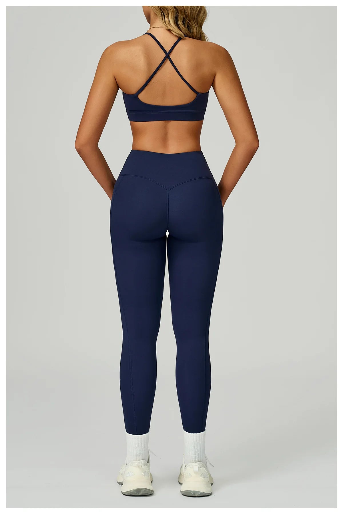 Navy blue X-back sports bra with matching leggings, back view