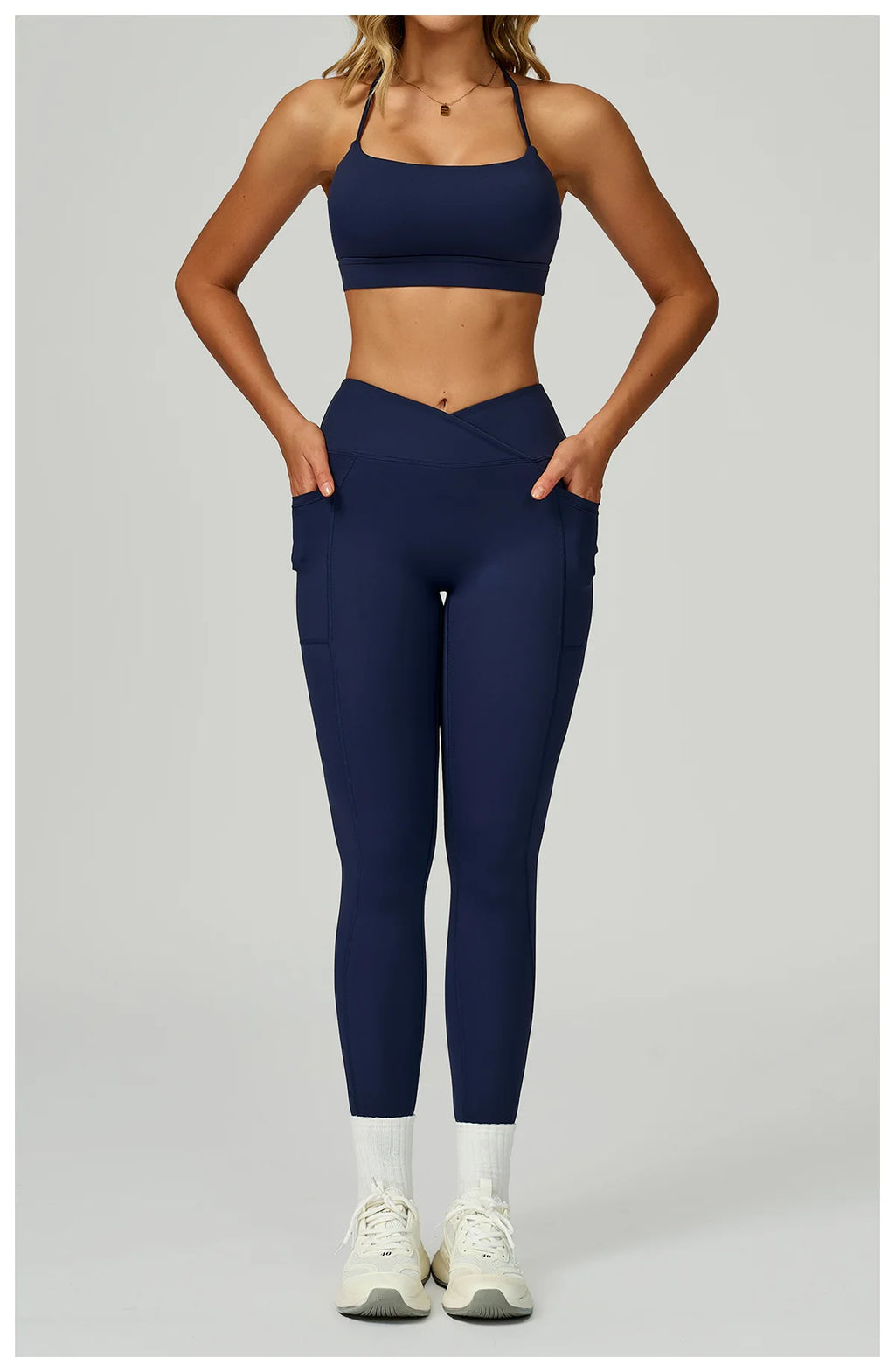 Navy blue sports bra and matching leggings set with side pockets