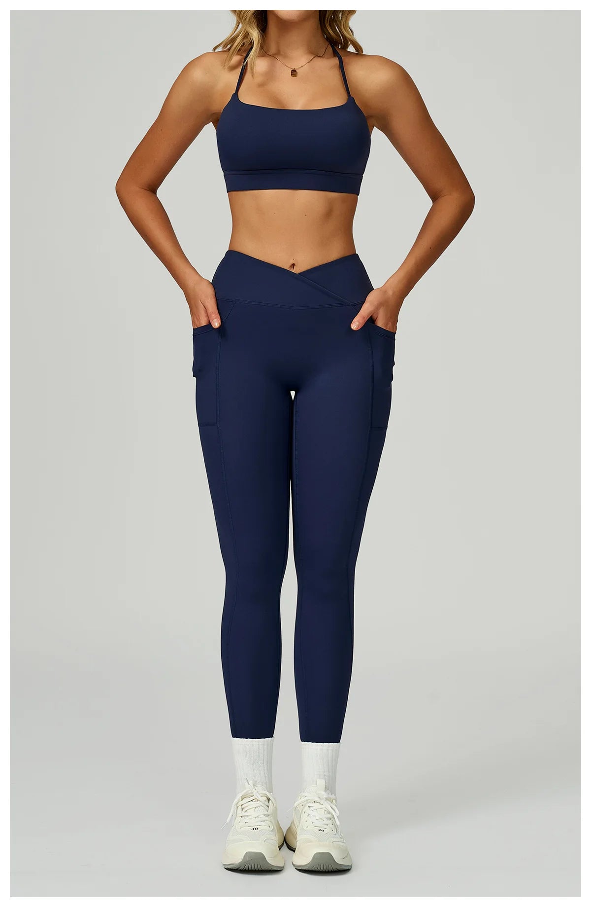Navy blue sports bra and matching leggings set with side pockets