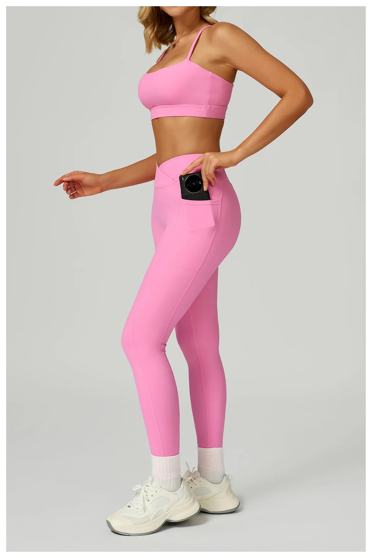 Pink sports bra and pocket leggings set; phone-sized pocket on hip