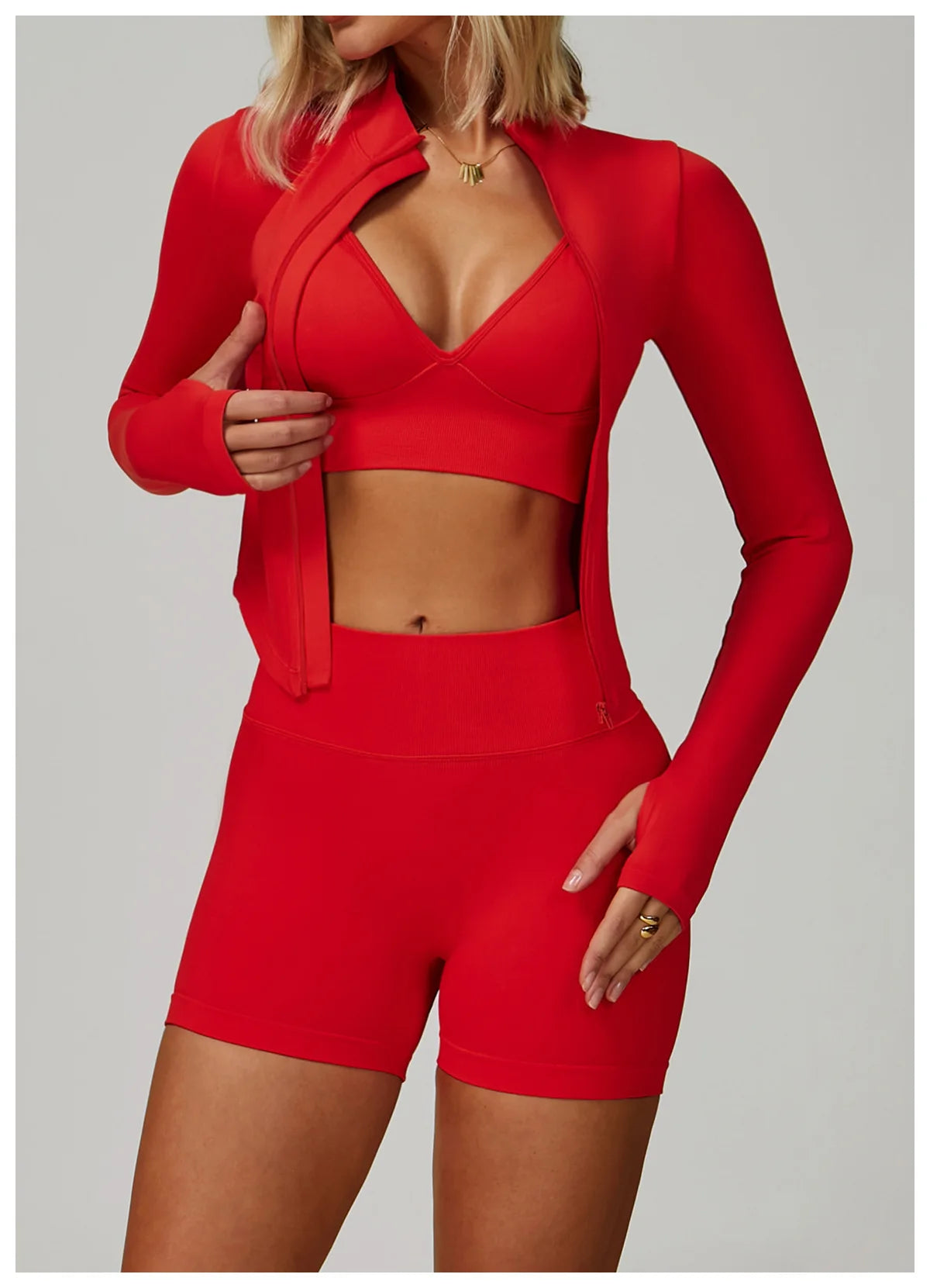 Xooie Fit women's matching activewear set in vibrant red with a crop jacket, sports bra, and shorts