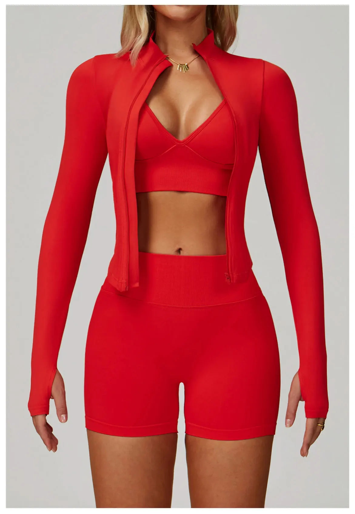 Red women's matching activewear set with full zip jacket, sports bra, and shorts for stylish workouts