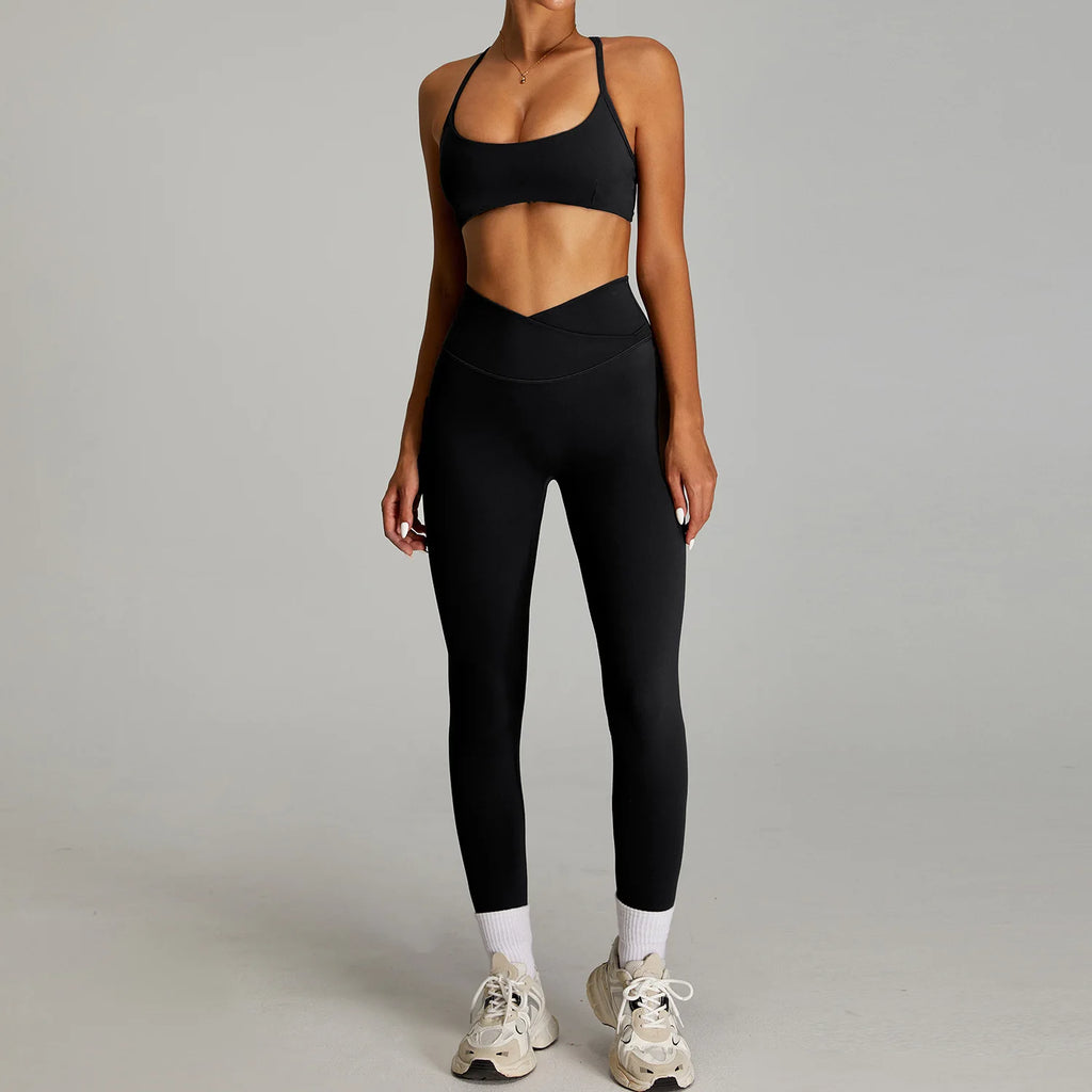 Black women's matching workout set by Xooie Fit featuring a crop top and high-waisted leggings