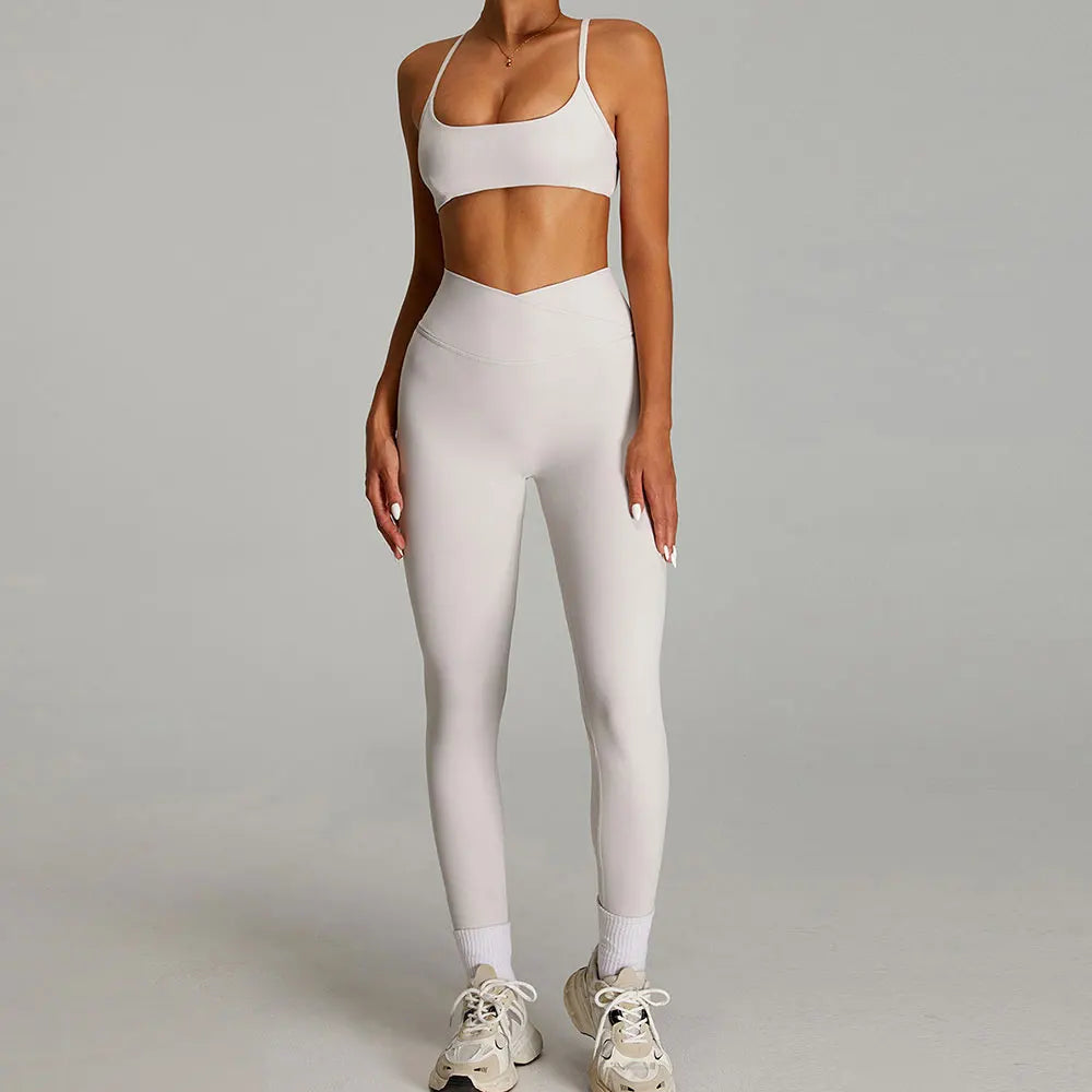 Xooie Fit women's matching workout set in light color featuring a crop top and high-waisted leggings