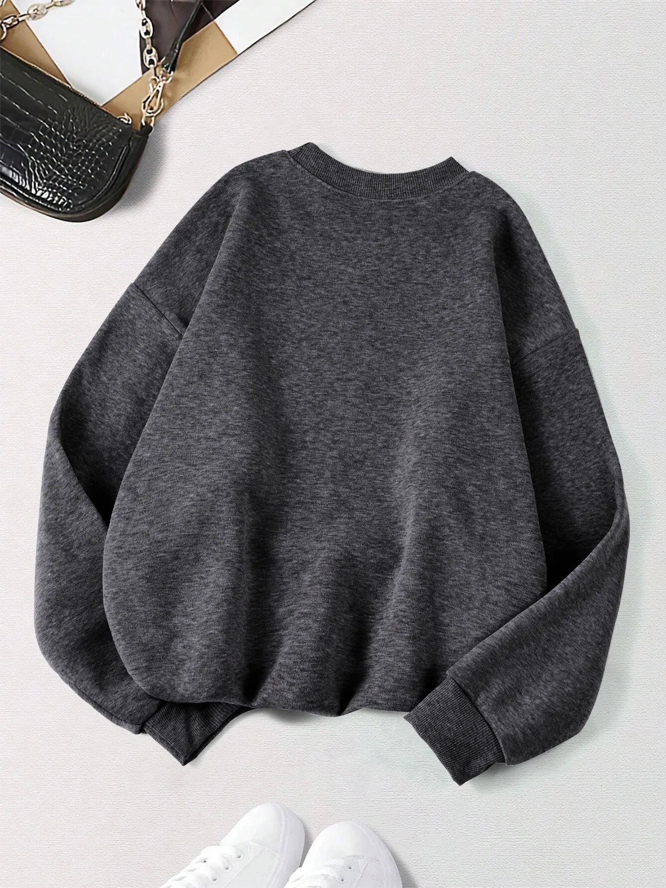 Back view of Xooie Fit women's oversized sweatshirt in dark gray, featuring a relaxed fit and soft fabric