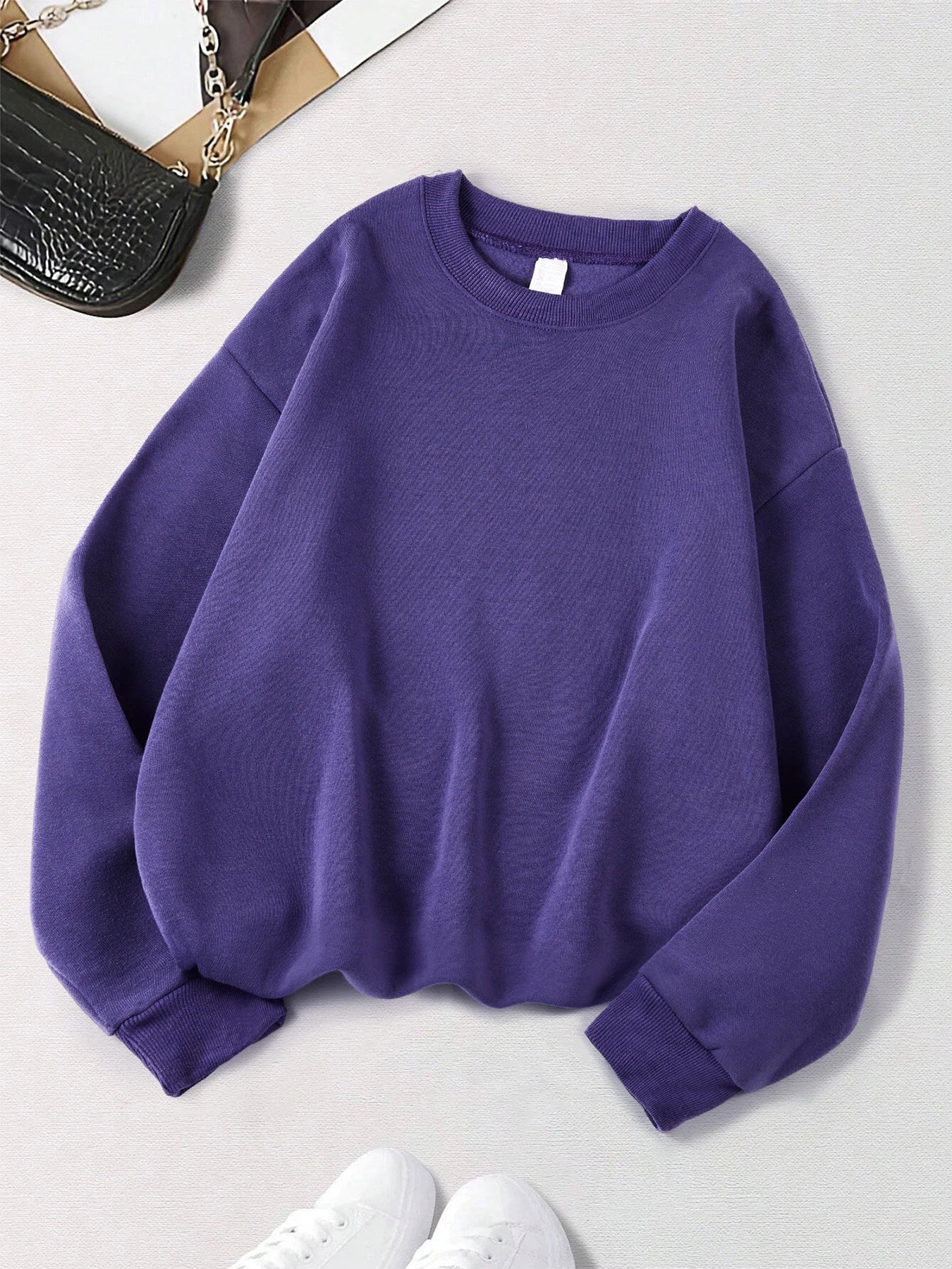 Xooie Fit women's oversized sweatshirt in purple, featuring a relaxed fit and soft material.