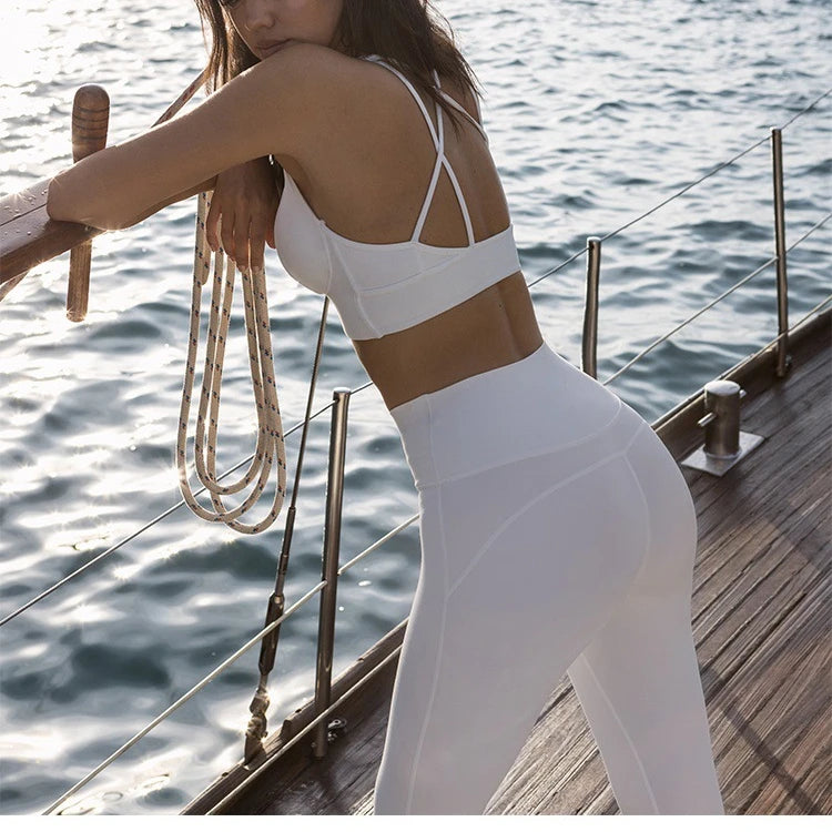 White sports bra with crisscross back straps and matching leggings