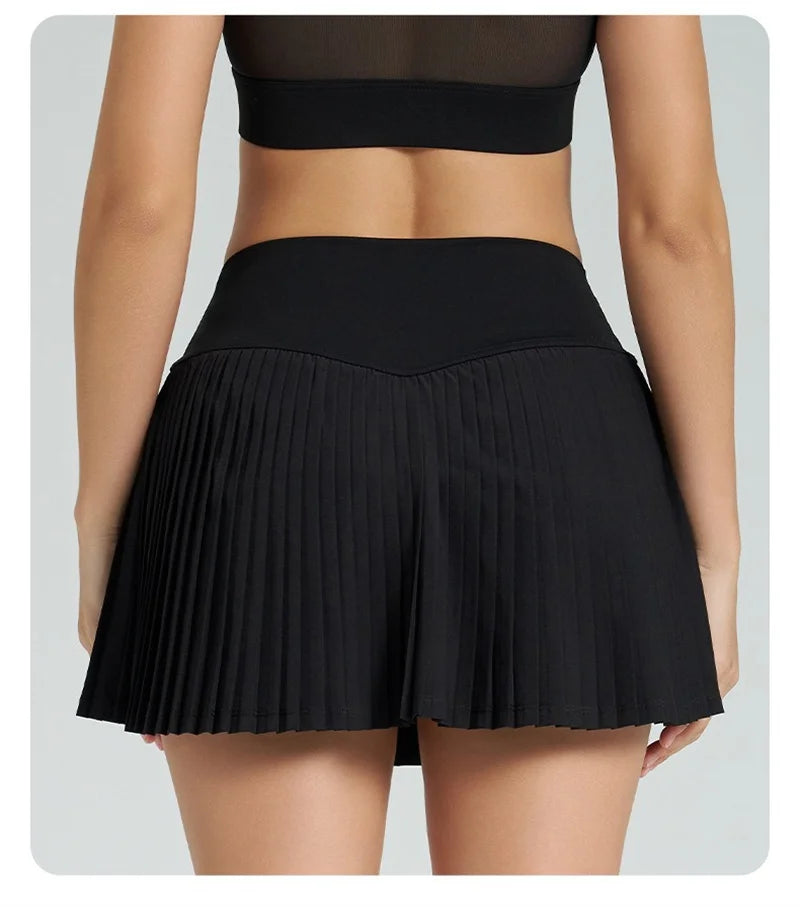 Xooie Fit women's tennis skort with phone pockets featuring a stylish pleated design in black