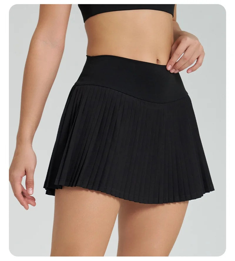 Xooie Fit women's tennis skort with phone pockets in black featuring a stylish pleated design