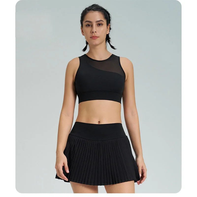 Xooie Fit women's tennis skort with phone pockets in black featuring a pleated design for comfort and style