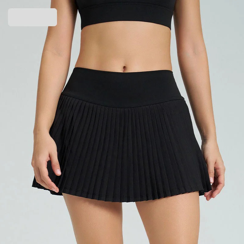 Xooie Fit women's tennis skort with phone pockets in black, featuring a pleated design for comfort and style