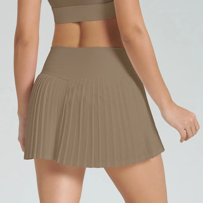 Xooie Fit women's tennis skort with phone pockets featuring stylish pleats and a comfortable fit