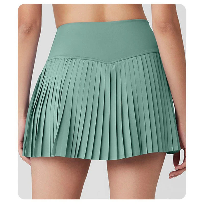 Xooie Fit women's tennis skort with phone pockets in green featuring a stylish pleated design