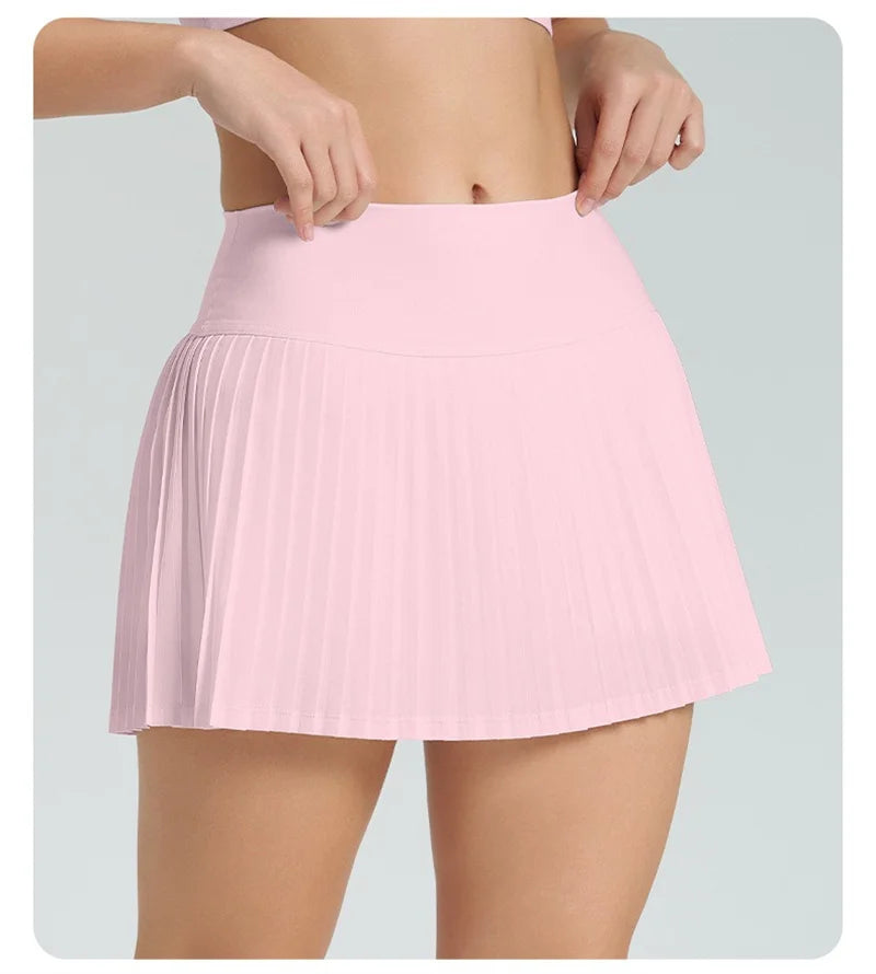 Xooie Fit women's tennis skort with phone pockets in soft pink for active wear and comfort