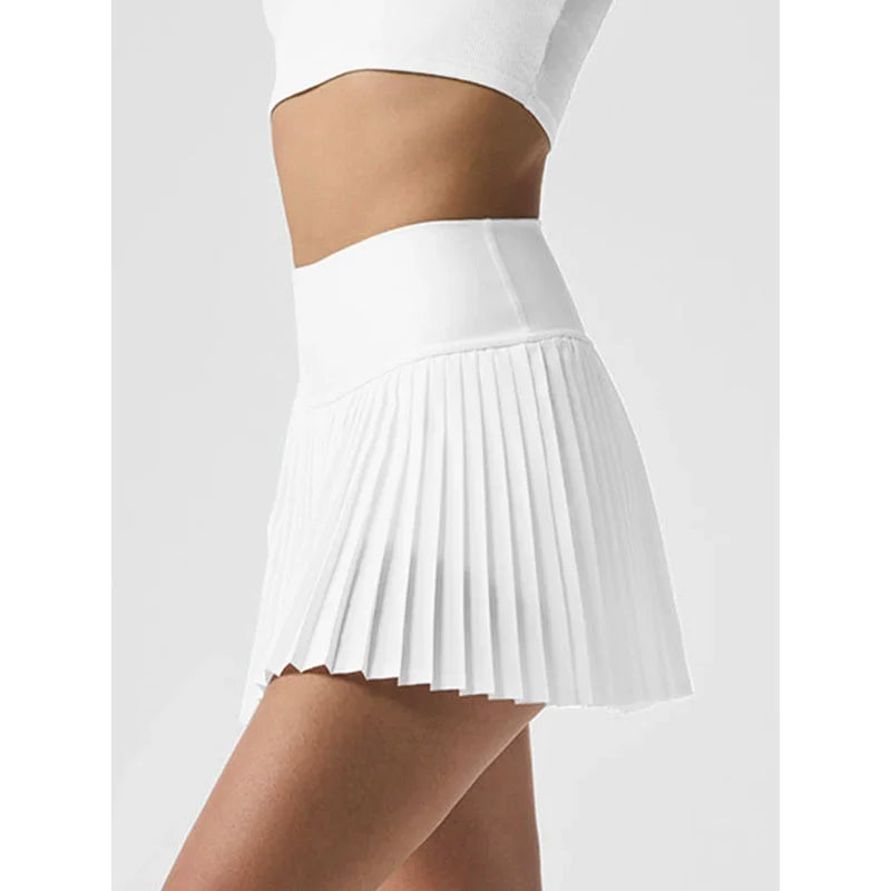 White Xooie Fit women's tennis skort with phone pockets featuring a pleated design