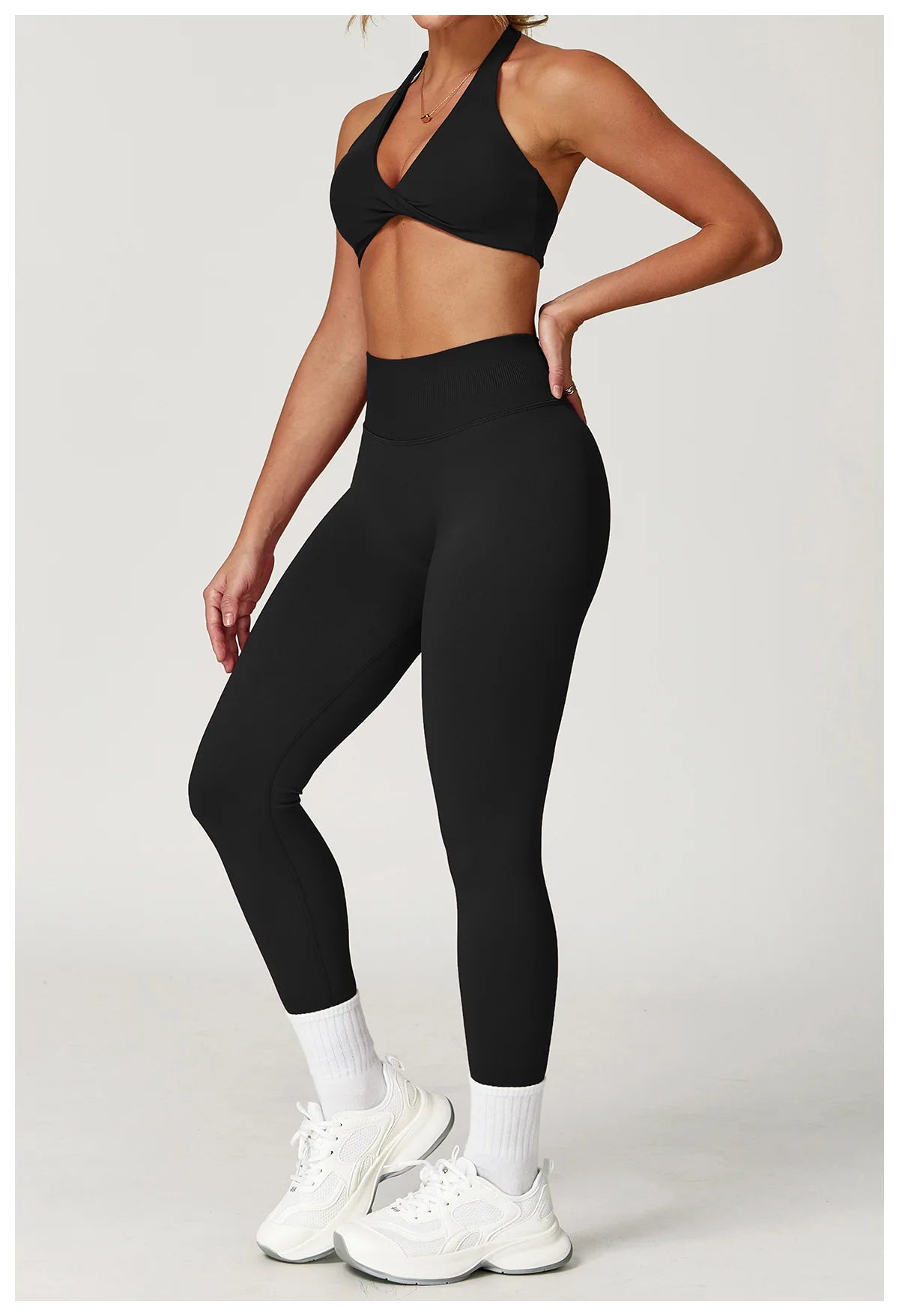 Stylish women's twist bra and high waist leggings set in black for fitness and comfort