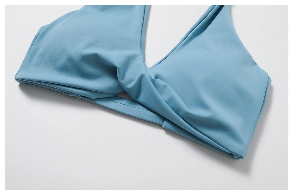 Women's twist bra and high waist leggings set featuring a light blue twist bra top