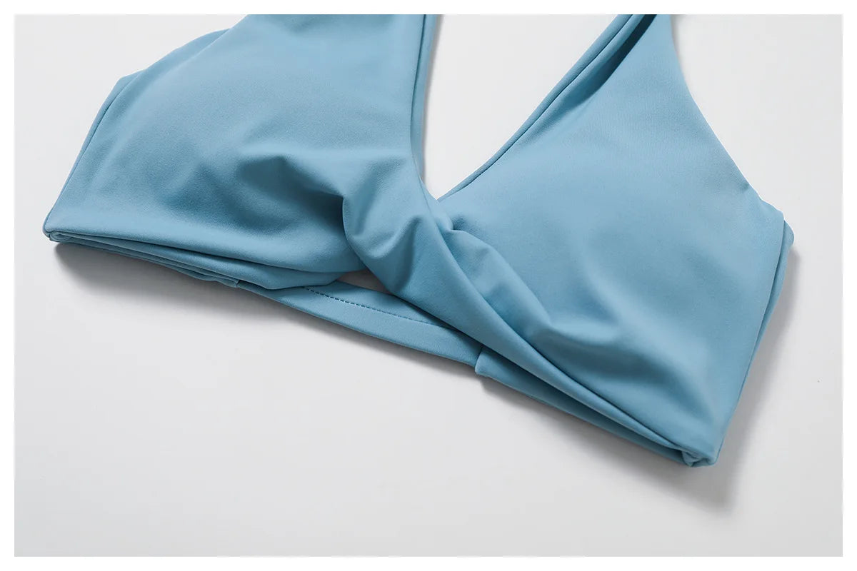 Women's twist bra and high waist leggings set featuring a light blue twist bra top