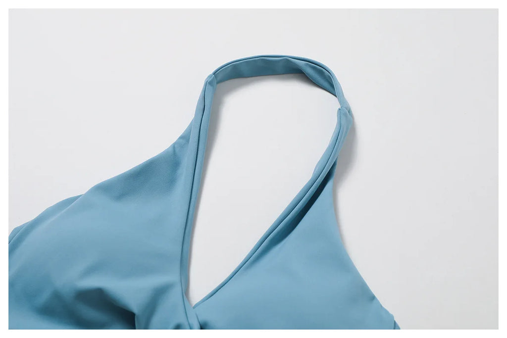 Close-up of Xooie Fit women's twist bra and high waist leggings set in blue fabric