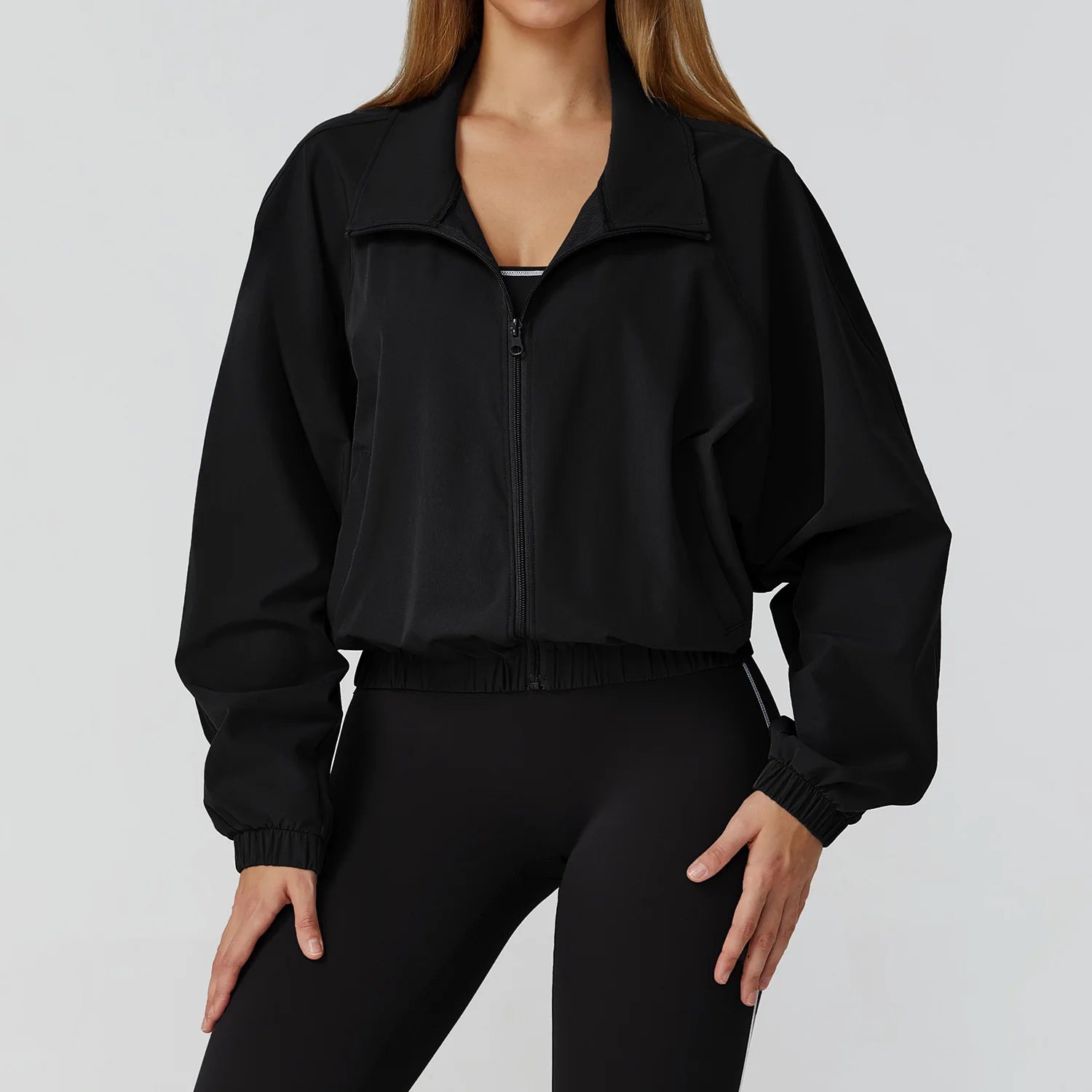 Stylish women's windproof fitness jacket by Xooie Fit in black with zip closure and comfortable fit