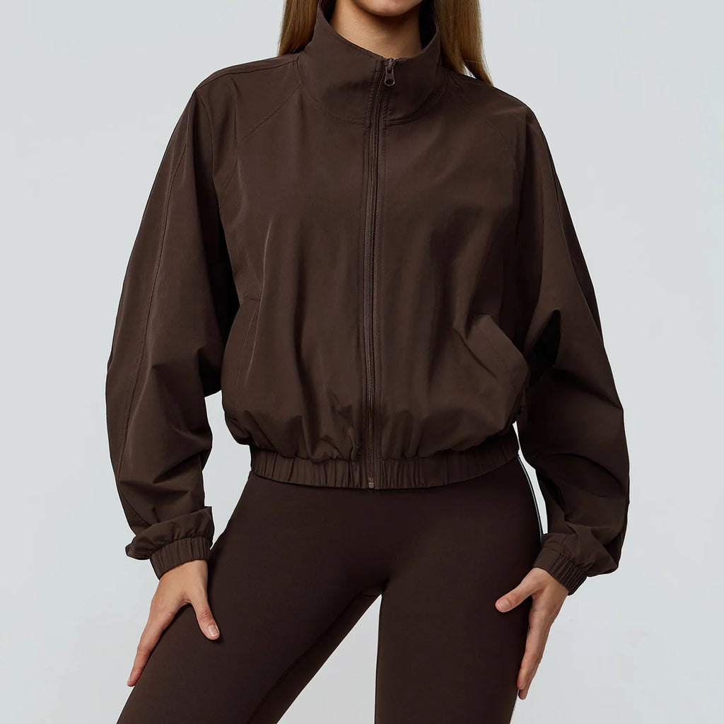 Xooie Fit women's windproof fitness jacket in brown with a zip front and elastic cuffs