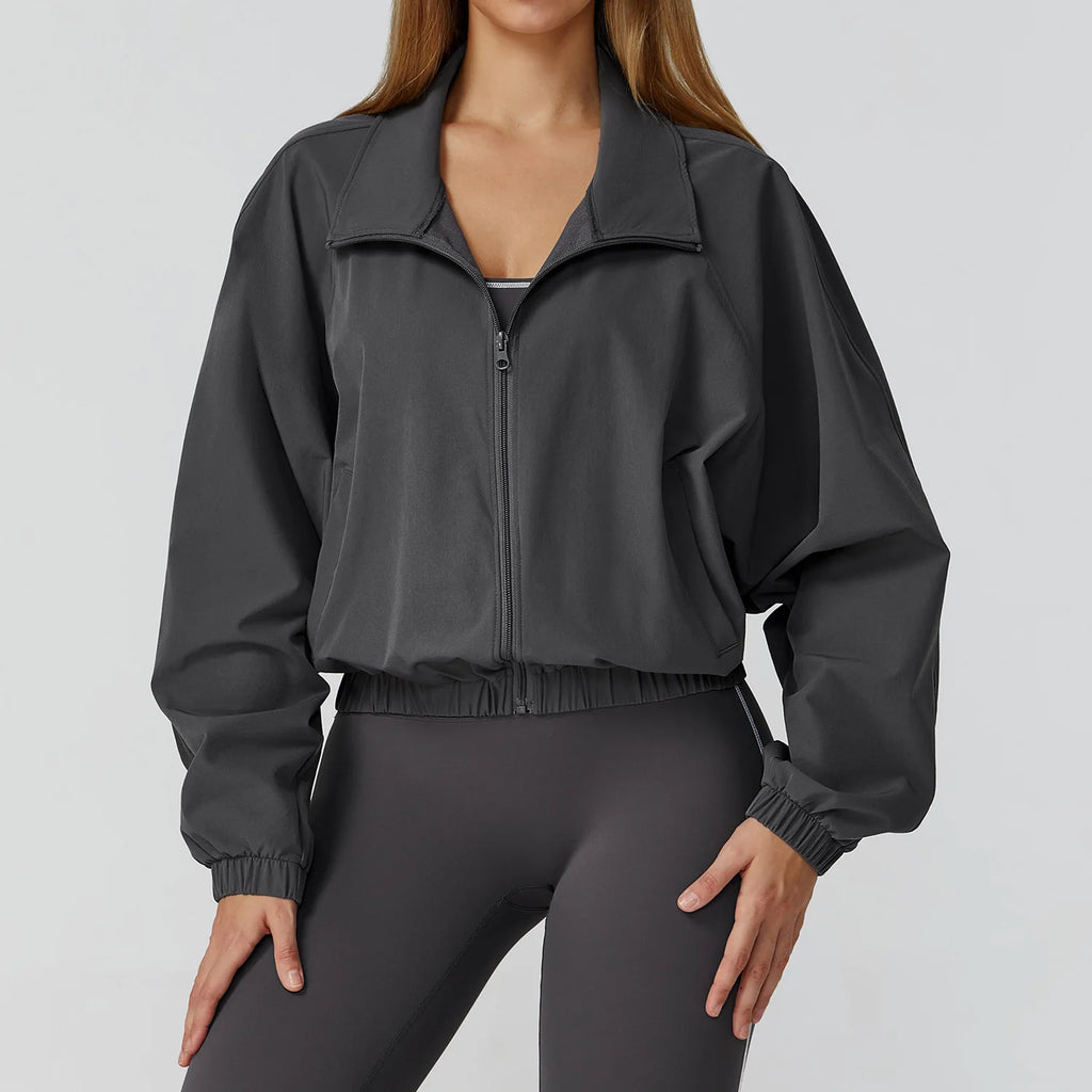 Xooie Fit women's windproof fitness jacket in gray with elastic cuffs and a sporty design
