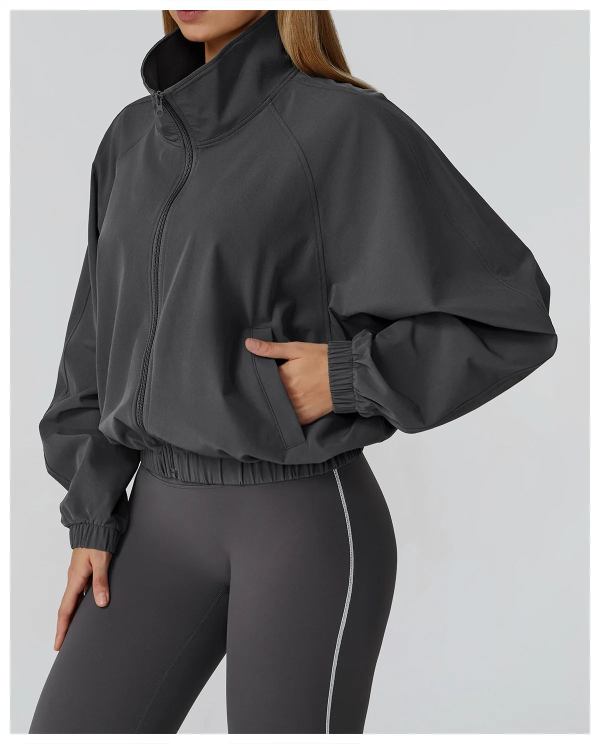 Xooie Fit women's windproof fitness jacket in gray with zip front and elastic cuffs for active wear